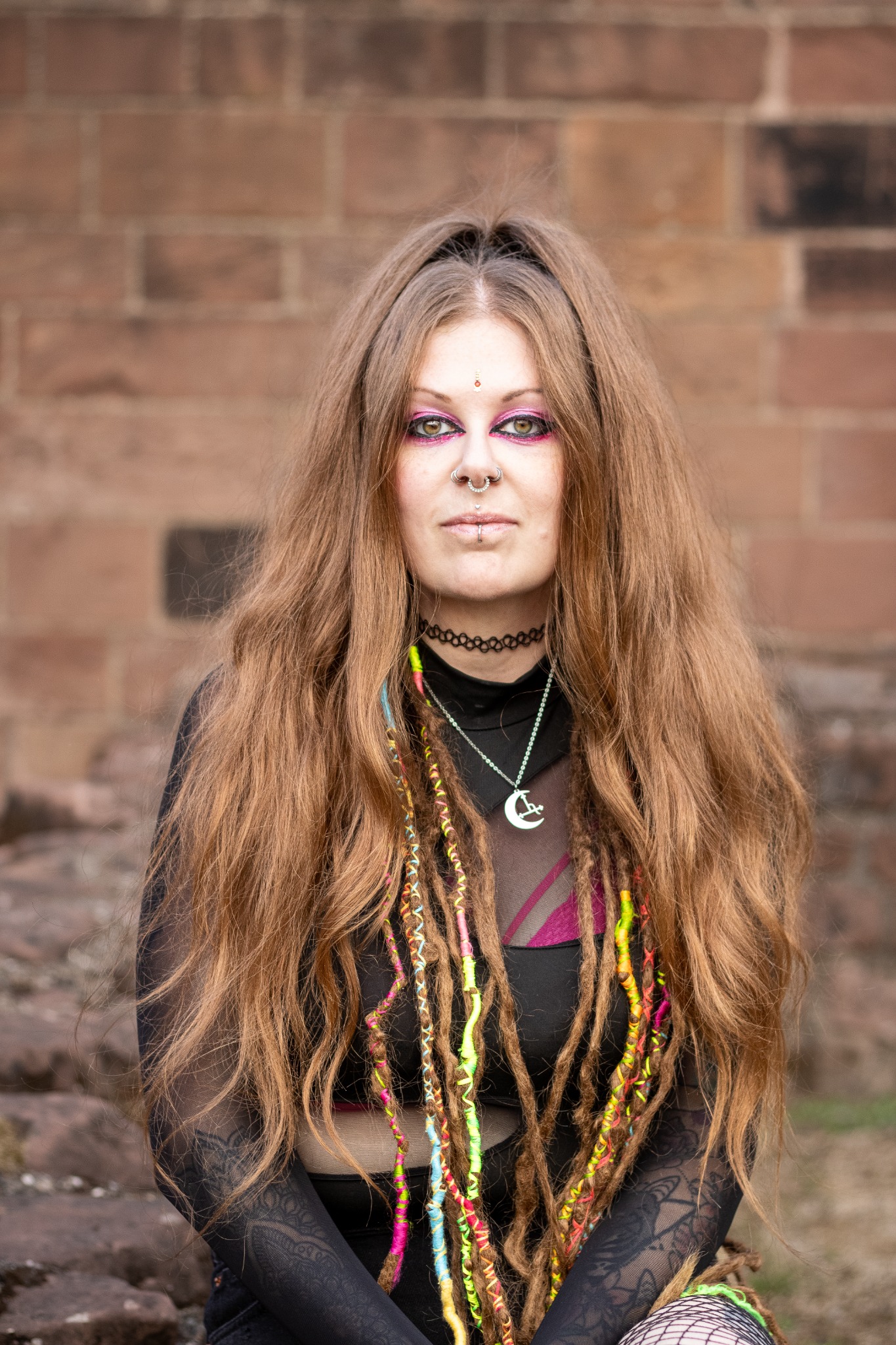 Portrait of a woman against stonework